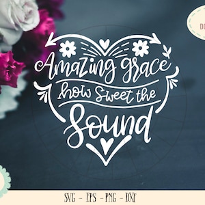 May include: A digital download graphic with the text "Amazing grace how Sweet the Sound" in a heart shape. The design includes floral accents and is in white on a dark blue background. A bouquet of flowers is in the upper left corner.