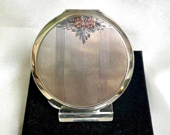 Pretty vintage English sterling silver powder compact. Engine turned with rose gold flower decor. Hallmarked with Queen's coronation 1953.