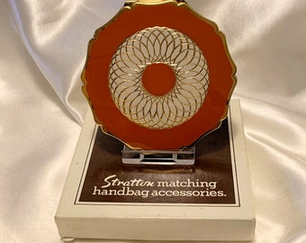 Vintage Stratton orange compact. Orange and white. Diamond cut Queen Convertible in original box. Unused. Made in England. 1970s