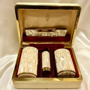Luxurious Kigu mother of pearl presentation set. Powder compact, cigarette case, lipstick case and comb case. Vintage 1963. Mint condition.