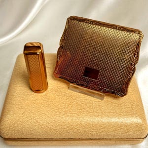 Stratton compact set. Empress loose powder compact and lipstick case. Engine turned gilt. Unused and original box. Vintage 1950s