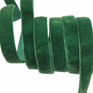 May include: A roll of dark green velvet ribbon. The ribbon is soft and plush, and it is perfect for adding a touch of elegance to any project.