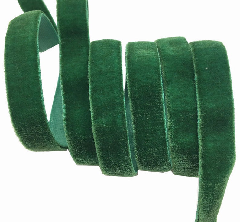 May include: A roll of dark green velvet ribbon. The ribbon is soft and plush, and it is perfect for adding a touch of elegance to any project.