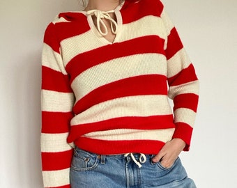 red sweater with one white stripe