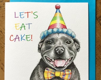 May include: A birthday card featuring a black and white illustration of a dog wearing a rainbow party hat and a yellow and orange bow tie. The text "Let's Eat Cake!" is written in rainbow colors.