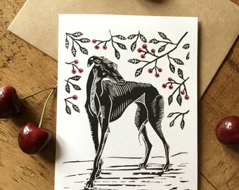 May include: A black and white illustration of a dog standing in front of a leafy branch with red berries. The dog is a greyhound with a long, slender body and a long, pointed snout. The illustration is printed on a white card.