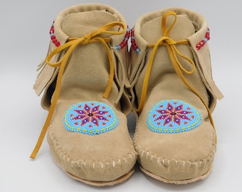 Women's Native American Inspired short boot moccasins with fringe. Handmade with genuine leather and a Beaded rosette.