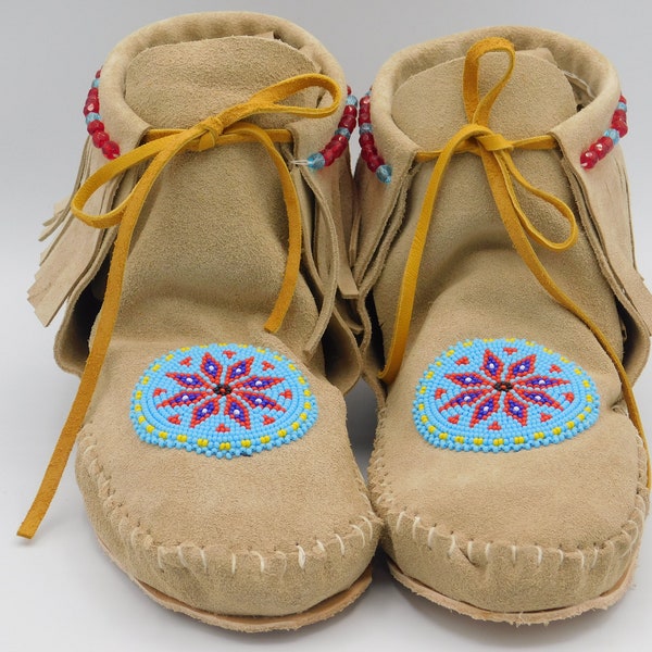 Women's Native American Inspired short boot moccasins with fringe. Handmade with genuine leather and a Beaded rosette.