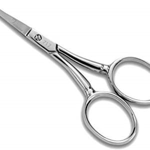 May include: Silver-toned grooming scissors with a pointed tip and a small oval ring on one handle. The handle has the number "7117" engraved on it.