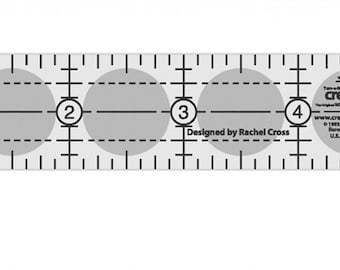 May include: A white plastic ruler with five circles marked 1 through 5. The ruler is designed by Rachel Cross for Creative Grids.