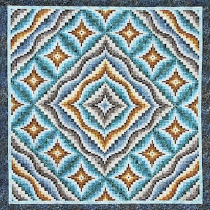 May include: A square quilt with a geometric pattern in shades of teal, blue, brown, gray, and gold. The design features diamond and star shapes, with a border in a darker teal. The quilt is likely handmade.