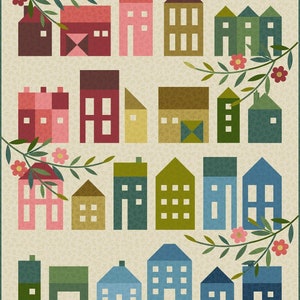 May include: A colorful quilt pattern featuring a variety of houses in different shapes and sizes. The houses are arranged in rows and are surrounded by green leaves and pink flowers.