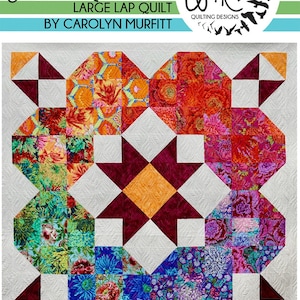 May include: A large lap quilt featuring a star design in the centre. The quilt is made from colourful fabric with floral patterns. The quilt is surrounded by a white border. The text "The Big Magenta Star Large Lap Quilt by Carolyn Murfitt" is at the top of the image. The text "Free Bird Quilting Designs" is at the top right of the image.
