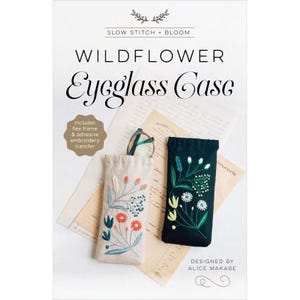 May include: A craft kit for making a wildflower eyeglass case. The kit includes a linen fabric case with a floral embroidery design, a black fabric case with a floral embroidery design, a flex frame, and an adhesive embroidery transfer.