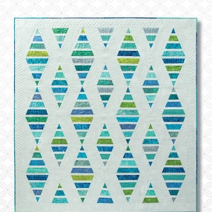 May include: A quilt pattern featuring a repeating design of blue, green, and white diamond shapes. The pattern is called "Sugar Sand Beach" and is from Atkinson Designs.
