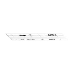 May include: A clear plastic ruler with a grid pattern and the text "Pineapple 1/2" and "DIY - Loc" printed on it. The ruler is designed for quilting and sewing projects.
