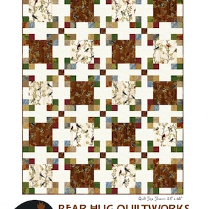 May include: A quilt pattern called "Square Pegs" featuring a repeating pattern of squares with a bird and branch design. The quilt is made with a variety of fabrics in shades of brown, green, blue, and red. The quilt is 54 inches by 68 inches. The pattern is by Bear Hug Quiltworks.