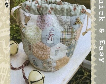 May include: A beige and brown patchwork fabric drawstring bag with a snowman design. The bag is labeled "All for Christmas Treat Bag" and "Quick & Easy".