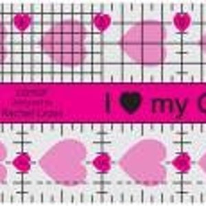 May include: Pink and white quilting ruler with a grid pattern, circles, hearts, and the text "I ♥ my Quilting Friends".