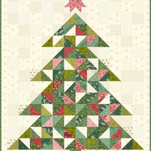 May include: A patchwork Christmas tree quilt with a pink star on top. The quilt is made of green, red, and pink fabric with a variety of patterns. The background is a cream color with a small green and white pattern.