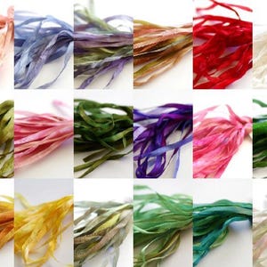 May include: A collection of colorful silk ribbons in various shades, including pink, blue, green, and purple. The ribbons are arranged in a grid, showcasing their textures and hues. Ideal for crafting and decorative purposes.