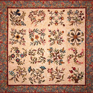 May include: A quilt with a cream background and a repeating pattern of brown, red, and blue floral designs. The quilt is framed with a red and blue border.