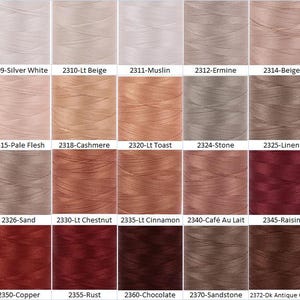 May include: A color chart of 18 different shades of thread, ranging from white to dark brown. The thread is wound around spools and labeled with numbers and names.