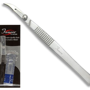 May include: A silver 5.5 inch stainless steel seam ripper with a curved blade and a black plastic handle. The ripper is packaged in a clear plastic bag with a white and black label that reads "Famore Cutlery Creative Quality Tools for Creative Minds!" and "5.5" Stainless Steel Seam".