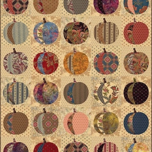 May include: A quilt block featuring a patchwork design of 36 pumpkin shapes in various colors and patterns. The pumpkins are arranged in a grid pattern on a cream background.