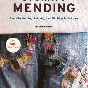 May include: A book titled "Creative Mending: Beautiful Darning, Patching and Stitching Techniques" by Hikaru Noguchi. The cover features a pair of blue jeans with colourful patches and the text "Over 300 Colour Photos".