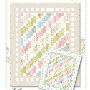 May include: Quilt pattern design for a quilt called "Aubrey" by Brenda Riddle Designs, home of Acorn Quilt & Gift Company. The pattern features a patchwork design with pink, green, blue, and white floral fabrics. The quilt is available in two sizes: 54 inches by 65 inches and 27 inches by 33 inches.