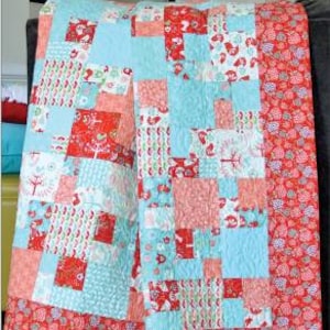 May include: A red, white and blue patchwork quilt with a "Tidbits" title and "Swirly Girls" logo. The quilt is made of squares of different fabrics and patterns.