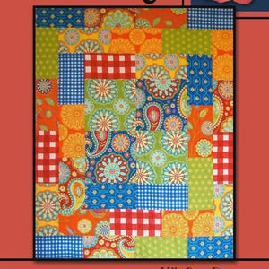 May include: A colorful patchwork quilt with floral and paisley patterns in shades of orange, blue, green, and yellow. The quilt has a red border with the text "On Stage" and "Villa Rosa Designs". A rose is in the upper right corner.