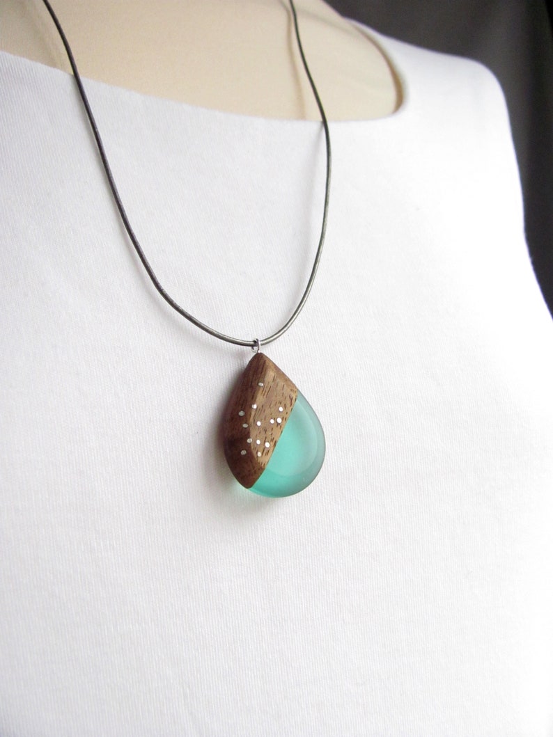 Drop-shaped pendant made of walnut wood and turquoise resin.