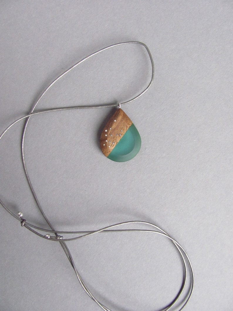 Drop-shaped pendant made of walnut wood and turquoise resin.