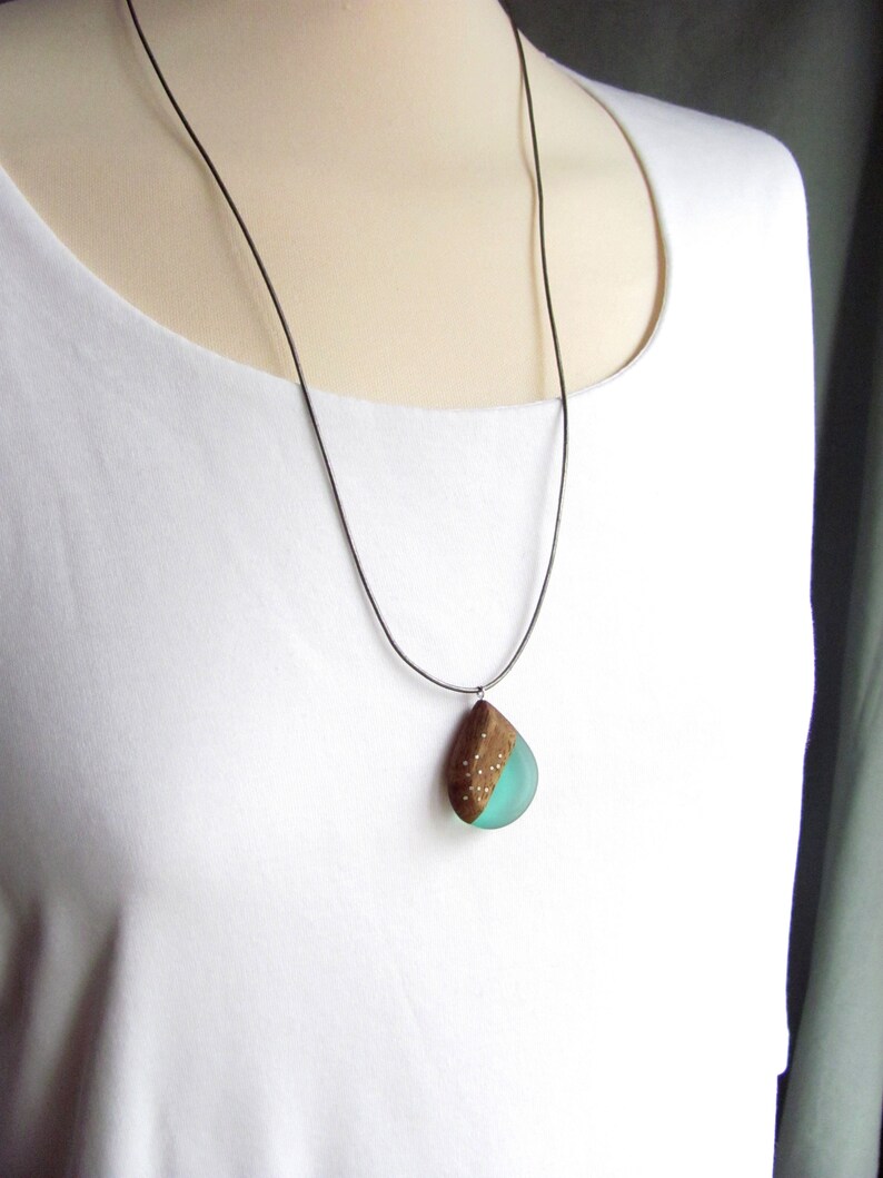 Drop-shaped pendant made of walnut wood and turquoise resin.