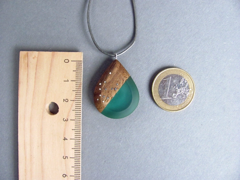Drop-shaped pendant made of walnut wood and turquoise resin.