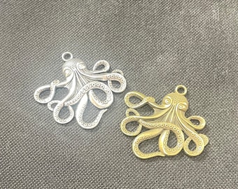 May include: Two silver octopus charms, one with a gold finish. The octopus charms have detailed tentacles and a textured surface.
