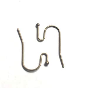 May include: Two antique brass-colored earring hooks on a white background. One hook is complete, featuring a curved bottom, a central loop, and a small ball at the top. The other hook is missing the top ball. Jewelry making supplies.