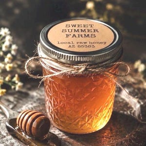 May include: A jar of local raw honey from Sweet Summer Farms, AZ 85383, with a brown label and a silver lid. The jar is wrapped with twine and sits next to a wooden honey dipper on a spoon.