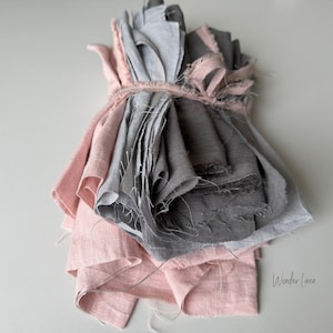 May include: A bundle of pink and gray linen fabric scraps tied together with a string. The fabric is soft and textured, and the colors are muted and calming. "Wonder Linen" is written in white text on the bottom right corner of the image.