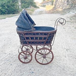 Old doll stroller, Victorian retro doll stroller, Antique wicker rattan doll stroller, Window display or photo studio decoration