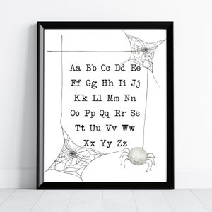 May include: Black and white alphabet chart featuring a spider and web design. The letters are arranged in pairs, with each letter repeated twice. The letters are in a typewriter font. The spider is white and has a smiling face. The web is black and has a simple design.