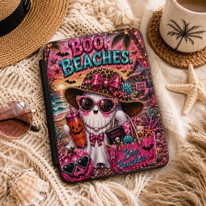 May include: A rectangular protective case featuring a graphic of a ghost wearing a leopard print hat and pink sunglasses, holding a jack-o'-lantern tumbler and a pink tote bag. The text reads BOO, BEACHES and Spooky Romance on a pink sunset beach.