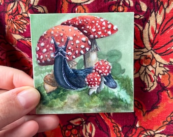 Black Slug with Amanita | weatherproof, dishwasher safe laminated vinyl sticker 3”