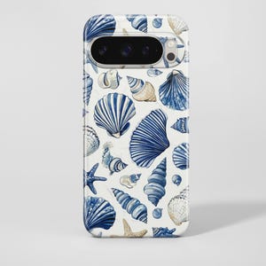 May include: A white phone case featuring a pattern of blue and tan seashells, starfish, and nautical elements. The design includes various shell shapes and sizes, creating a coastal or beach-themed aesthetic. The case has a glossy finish.