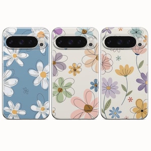 May include: Three phone cases with floral designs. The cases have a clear border and a camera cutout. The floral patterns include daisies and other flowers in various colours, set against backgrounds of blue, cream, and off-white.