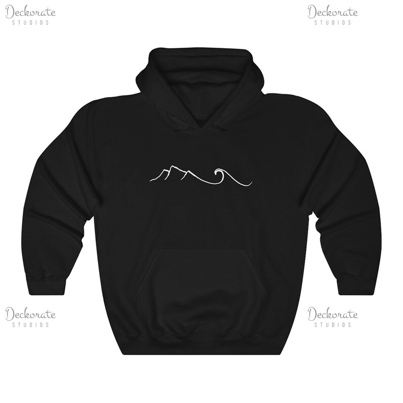 May include: Black hooded sweatshirt with a white minimalist mountain and wave design. The sweatshirt features a front pocket and a drawstring hood. The design is centered on the chest. The brand name "Deckorate Studios" is printed in white on the top left and right corners.