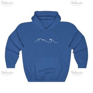 May include: Royal blue hooded sweatshirt with a white mountain and wave design. The sweatshirt has a front pocket and a drawstring hood. The design is a simple line drawing of a mountain range and ocean waves.