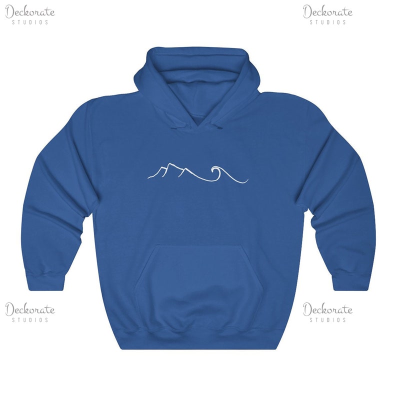 May include: Royal blue hooded sweatshirt with a white mountain and wave design. The sweatshirt has a front pocket and a drawstring hood. The design is a simple line drawing of a mountain range and ocean waves.